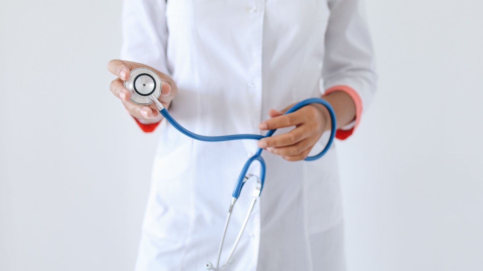 Doctor in a white coat holding a stethoscope