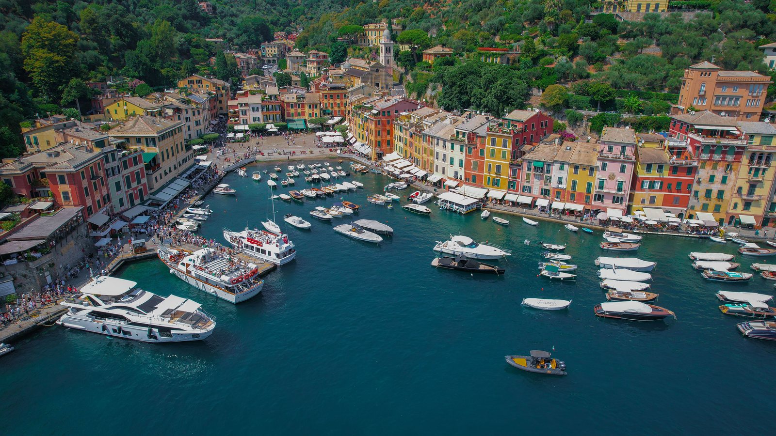 Aerial view of Portofino harbour with colourful houses, yachts and tenders in the bay